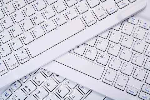 Closeup of three white computer keyboards with a wireless connection Stock Photos