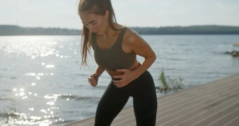 Closeup tilt up and down of young motivated fit woman in sportswear training 動画素材 125640575