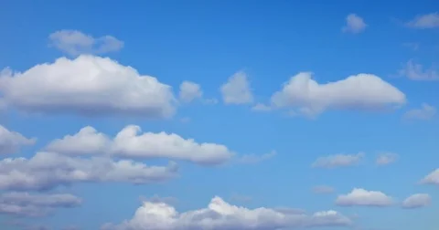 Closeup time-lapse of white fluffy clouds moving fast Stock Footage 83875848