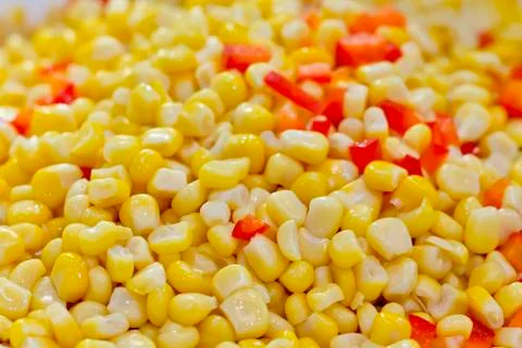 Closeup of tinned whole kernel corn and carrots, it could be used as backgrou Stock Photos