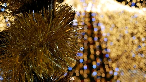 Closeup of tinsel on pole on background light garland Christmas tree. Copy space Stock Footage 122297045