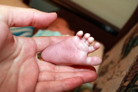 Closeup tiny newborn baby foot Stock Photos