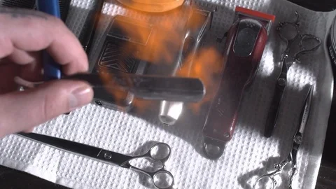 Closeup tool razor disinfection with the help of a roasting fire in the Stock-Footage 107653925
