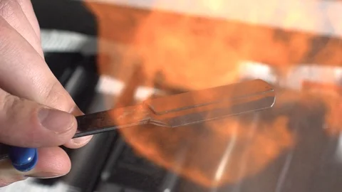 Closeup tool razor disinfection with the help of a roasting fire in the Stock Footage 107653979