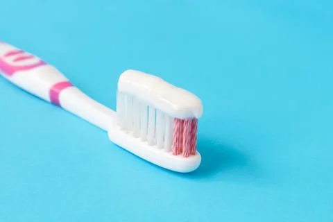 Closeup toothpaste with toothbrush on blue background Stock Photos