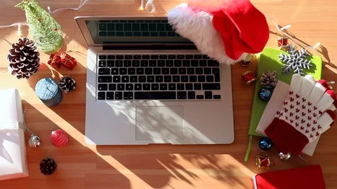Closeup top of Christmas decorated table with modern laptop and sunshine on back Video stock 121739086