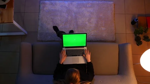 Closeup top shoot of pretty female using the laptop with green screen while Stock Footage 106965847