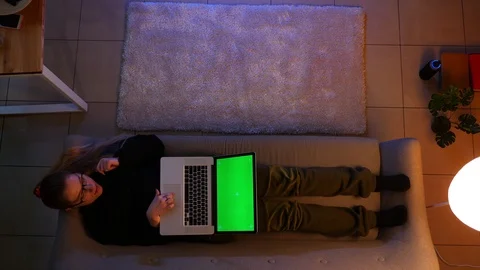 Closeup top shoot of pretty female typing on the laptop with green screen while Video stock 106966128