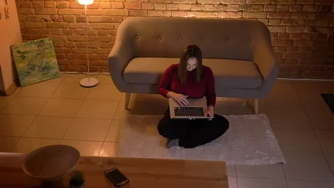 Closeup top shoot of young pretty caucasian female using the laptop sitting on Stock-Footage 103676474