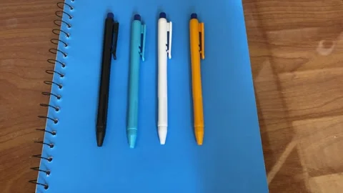 Closeup Top View of 4 Multiple Colours Beautiful Ball Pens Stock Footage 293949853