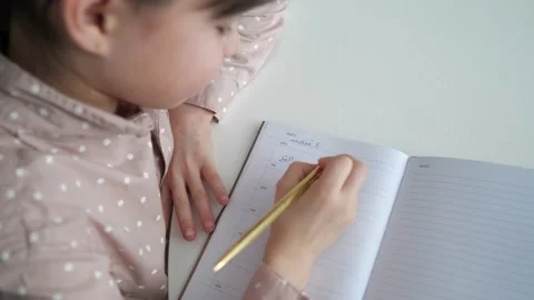 Closeup top view of child write in notebook. Little kid girl student learning Video stock 234989754