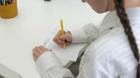 Closeup top view of child write in notebook. Little kid girl student learning Stock Footage 235670053