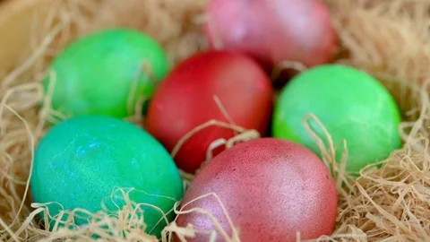 Closeup top view Colorful easter eggs lie on a bacon in a basket. Stock Footage 125614777