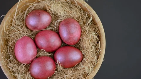 Closeup top view Colorful easter eggs lie on a bacon in a basket Stock Footage 125614831