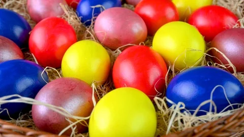 Closeup top view Colorful easter eggs lie on a bacon in a basket. Stock Footage 125618630