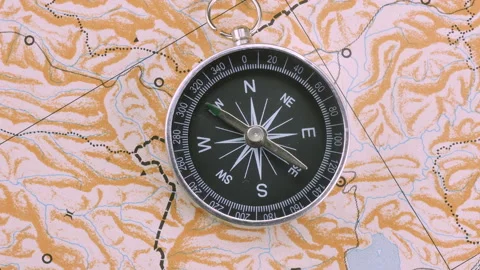 Closeup top view compass rotating on blank map Stock Footage 140742687