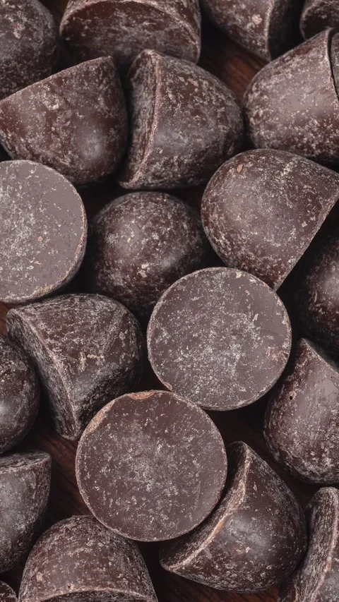 Closeup, top view of dark chocolate chips. Food backdrop Stock Footage 282391649