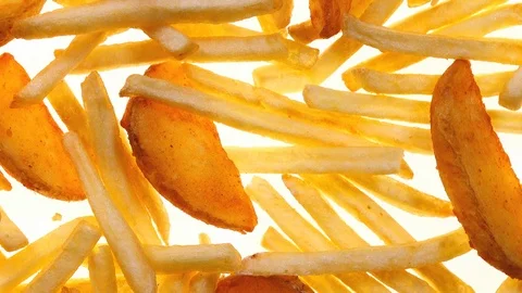 Closeup top view of fried potato chips and wedges rotating on white in 4K 库存影片 86098527
