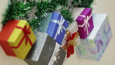 Closeup top view of many New Year's gifts under beautiful green tree Stock Footage 227206024