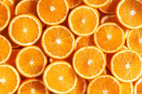 Closeup top view of pattern, laid out slices of juicy oranges on background.  Stock Photos