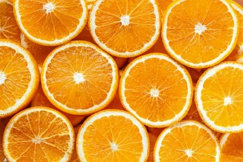 Closeup top view of pattern, laid out slices of juicy oranges on background.  Stock Photos