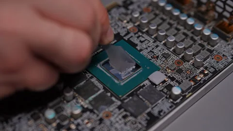 Closeup top view precise application of thermal paste to GPU chip for optimal Video stock 292006359