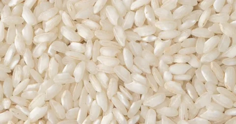 Closeup, top view of raw carnaroli risotto rice. Food backdrop Stock Footage 199969658