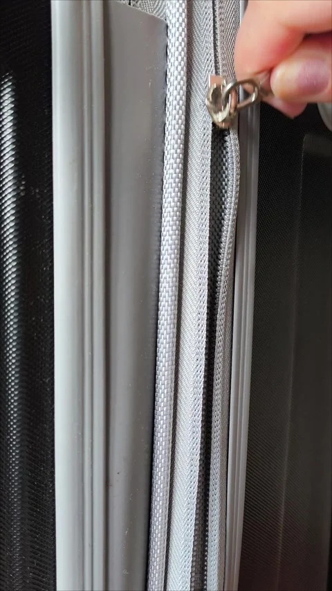 Closeup top view of silver zipper of hard shelled suitcase, new and clean Video stock 313833853