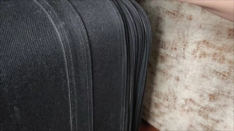 Closeup top view of silver zipper of hard shelled suitcase, new and clean Stock Footage 313833983