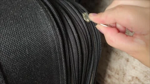 Closeup top view of silver zipper of hard shelled suitcase, new and clean Stock Footage 313834017