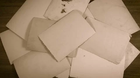 Closeup top view of stack of old vintage paper photos appear stacked together Stock Footage 147505976