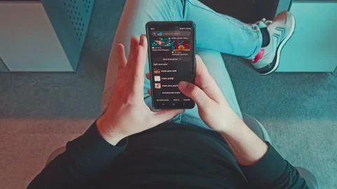 Closeup Top View Trader Hands with Mobile Phone Checking Stock Market Stock Footage 339942185