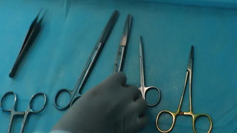 Closeup top view of unrecognizable surgeon taking surgical scissors from Stock Footage 262029756