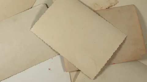 Closeup top view video of stack of back sides of old vintage photos Stock Footage 145936073