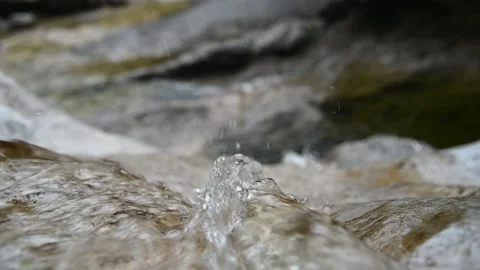 Closeup of the top a waterfall with drops squirting (slow motion, bokeh) Stock Footage 212742856