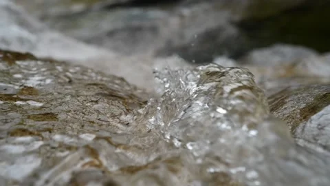 Closeup of the top a waterfall of a mountain river (bokeh, slow motion) Video stock 212743360