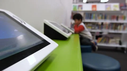 Closeup of a touchscreen digital play pad in a library for young children Stock Footage 244142201