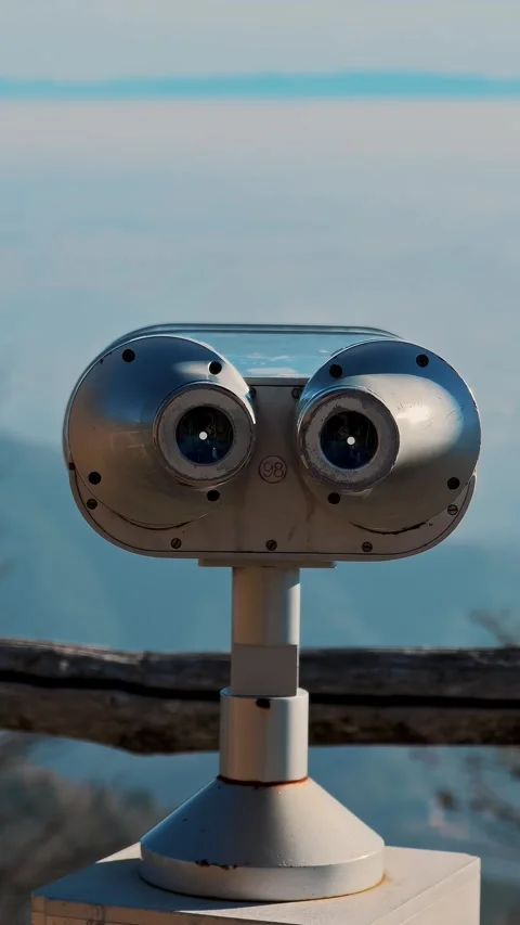 Closeup of tourist binoculars at viewing platform with view of misty mountains Stock Footage 324849771