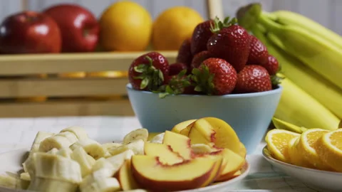Closeup tracking shot across delicious strawberries, bananas, peaches, oranges, Stock Footage 341197785