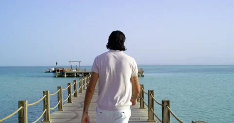 Closeup tracking shot view of a man walking on deck in the sea Stock-Footage 209945865