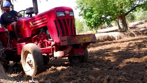 Closeup of Tractor and its plough during plowing of field Stock Footage 163262742