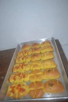 Closeup of a tray full of bread that has just come out of the oven Stock Photos