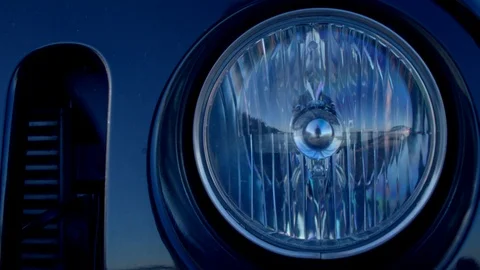 Closeup of the turning on headlight of a car. Video stock 85501593