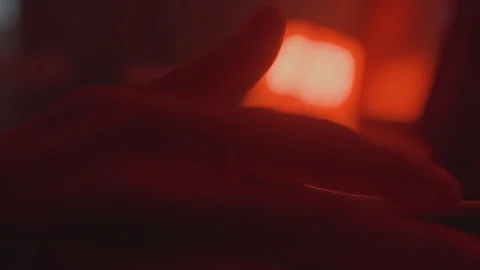 Closeup turntable stylus on vinyl, dim red lamp glow, hand cueing record Stock Footage 337315959