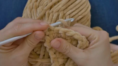 Closeup tutorial by woman on step by step knitting with beige yarn. Favorite Video stock 256298262