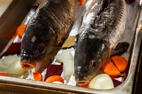 Closeup two big stuffed fish ready to cook on baking tray Stock Photos