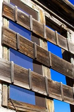 Closeup of two boarded up windows in an old building, Jerome, Arizona. Stock Photos