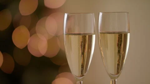 Closeup Of Two Bubbling Champagne Glasses The Backdrop Of Festive Decorations Stock Footage 143054907