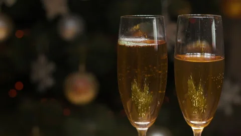 Closeup Of Two Bubbling Champagne Glasses Against The Backdrop Video stock 259048392