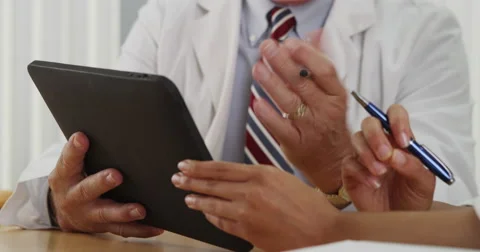 Closeup of two doctors using a tablet in the office Stock Footage 58353857